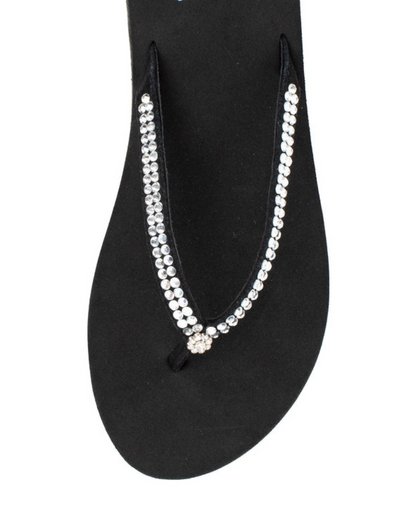Top view of a black wedge sandal with rhinestones on the strap on a white backdrop. The sandal has 1.75" heel height and 0.75" platform height.
