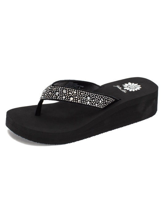 Front side view of a black wedge sandal with rhinestones on the strap on a white backdrop.