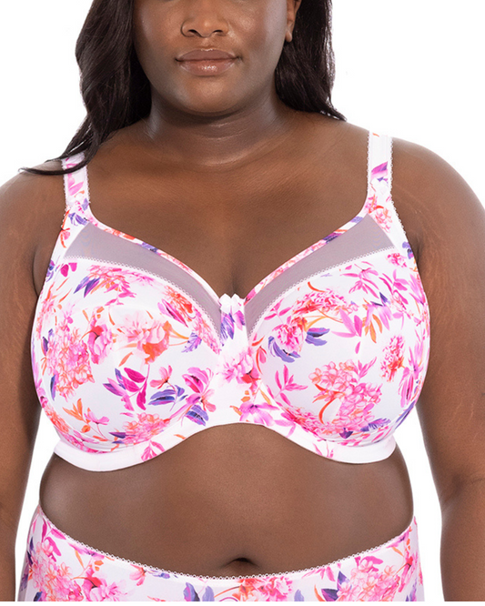 A model wearing a cut and sew underwire banded bra in white with a pink floral pattern