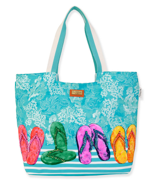 Blue tote bang with a sketch drawing of multicolored flip flops in red, green, pink and yellow with coral design in the background