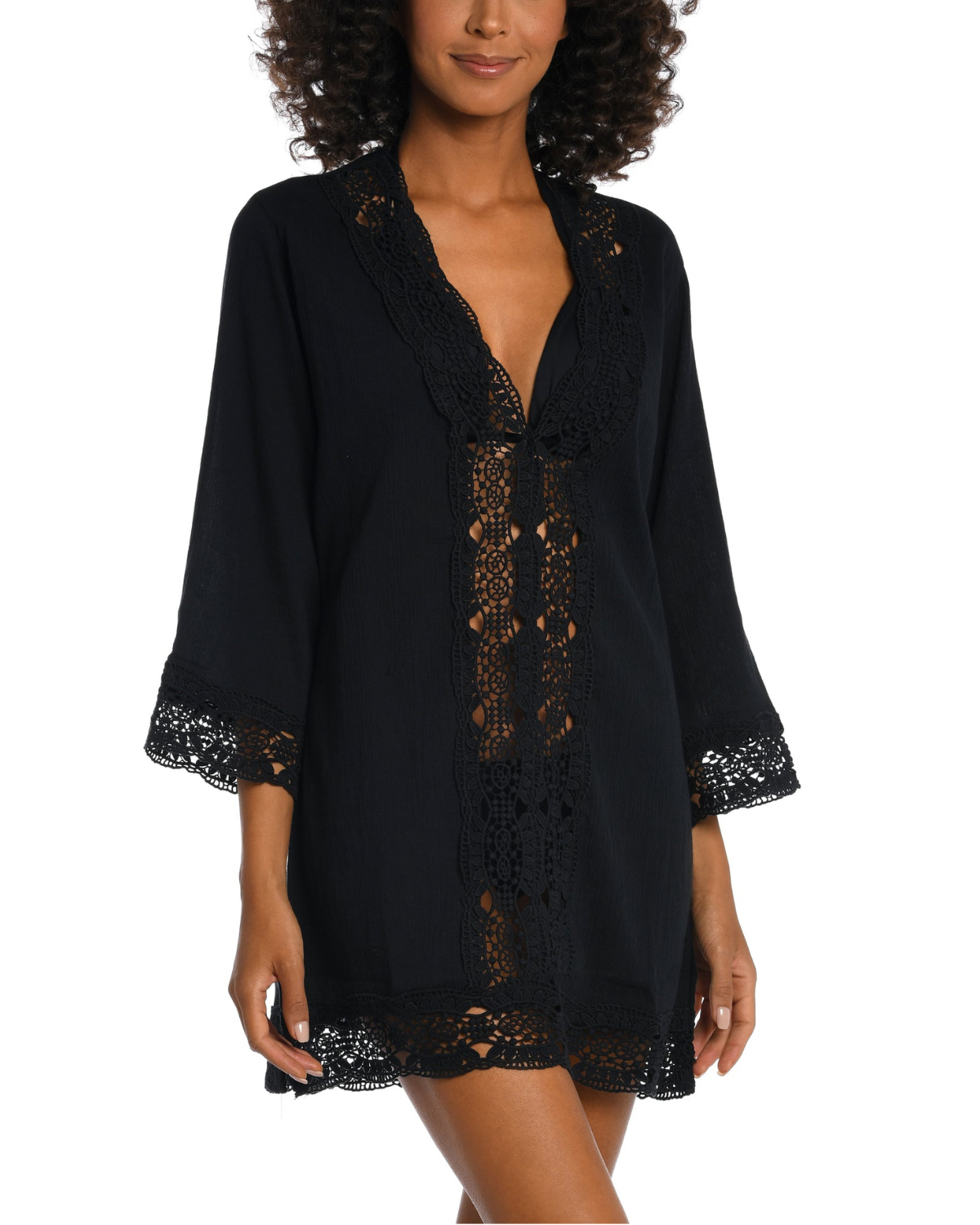 Model wearing a 3/4 sleeve v-neck tunic with a crochet trim in black