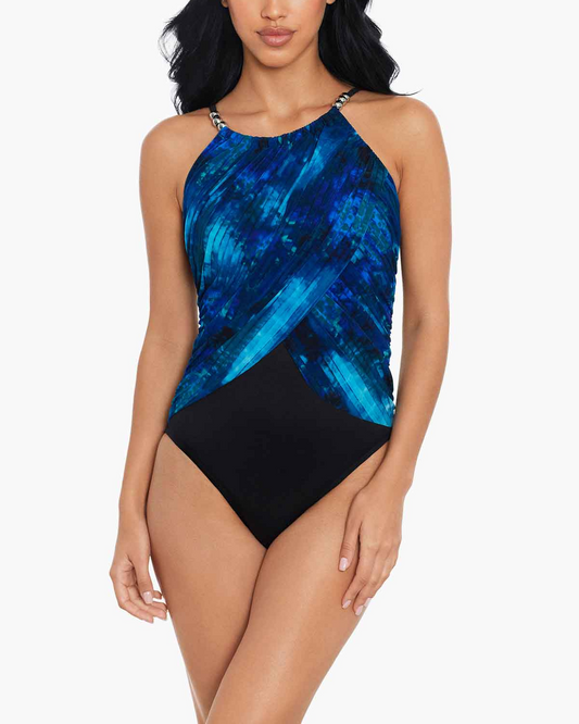 Model wearing a one piece high neck swimsuit in a black, blue, navy and white abstract print