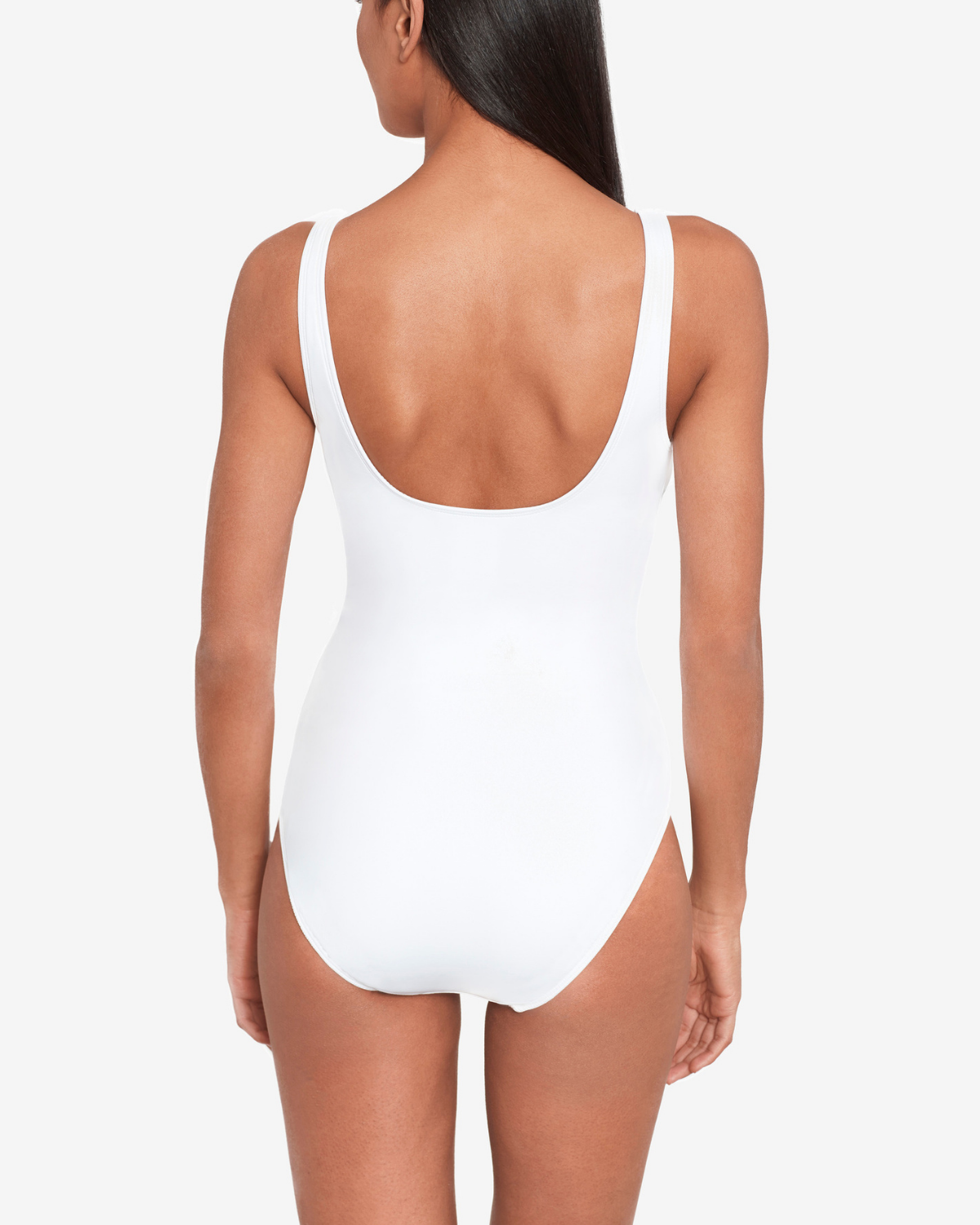 Model wearing a v-neck one piece with a ring detail and shirred torso in white