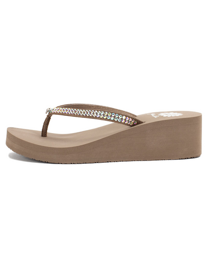 Side view of a taupe wedge sandal with rhinestones on the strap on a white backdrop. The sandal has 1.75" heel height and 0.75" platform height.