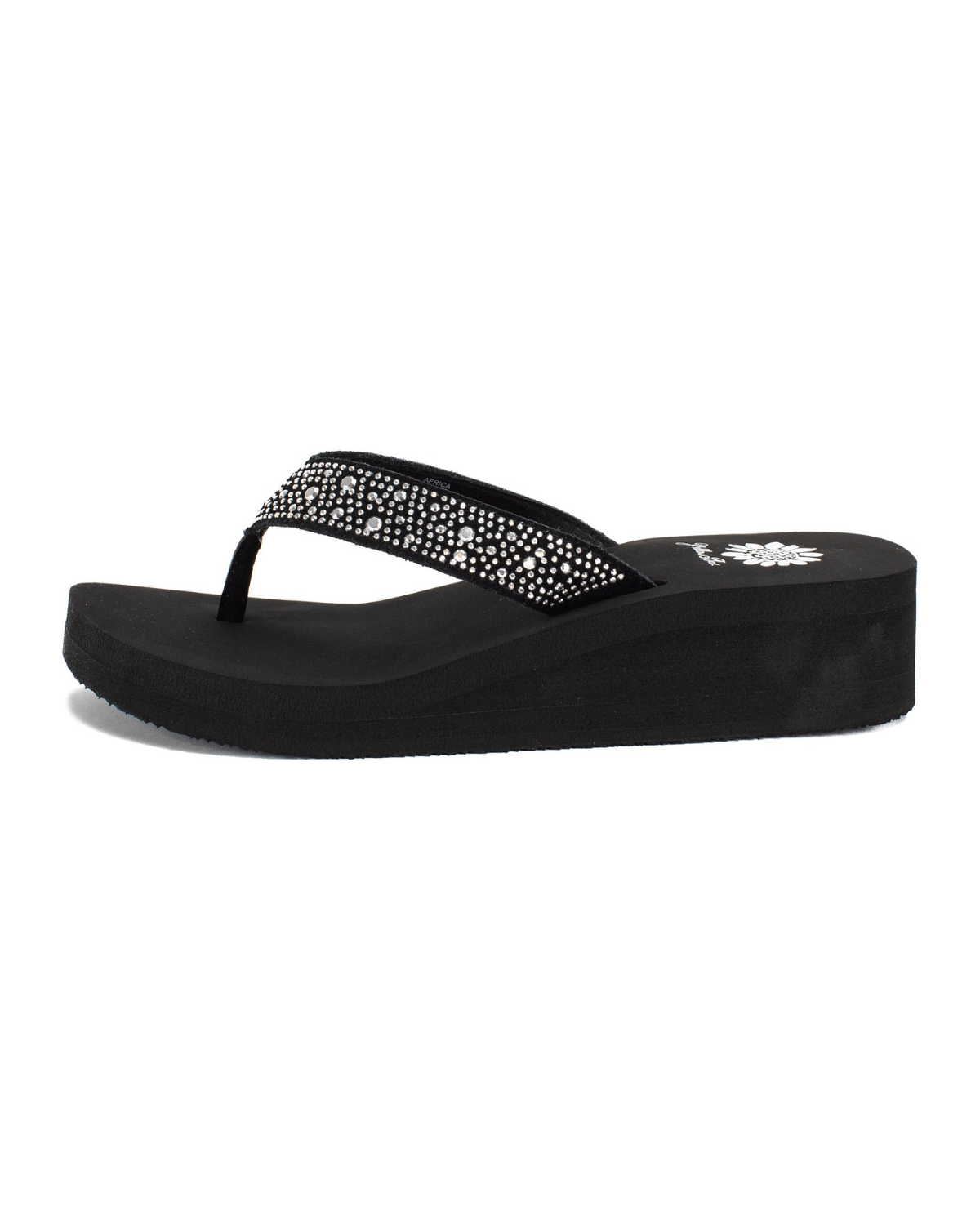 Side view of a black wedge sandal with rhinestones on the strap on a white backdrop.