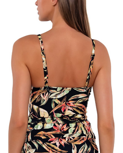 Model wearing a tankini top with shirred mid section in a black, green and red tropical print. 