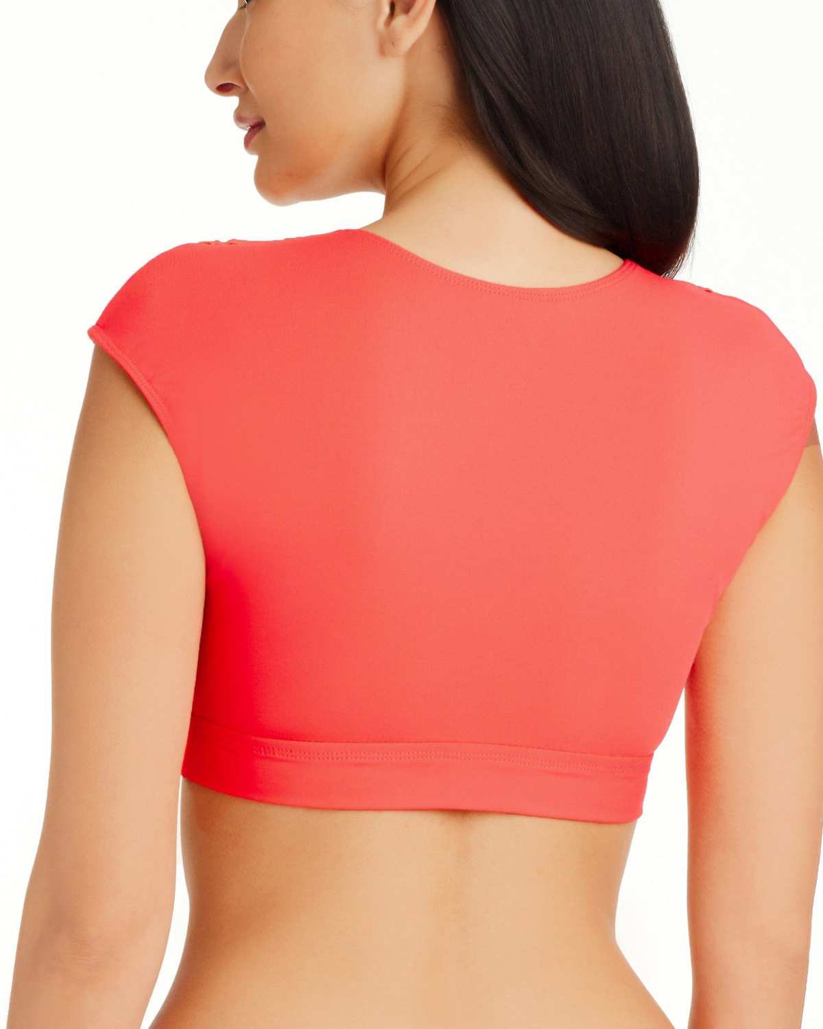 Model wearing a v neck crop top cap sleeve bikini top in coral