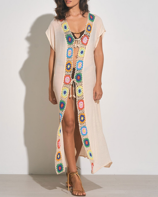 Model wearing a maxi length short sleeve kimono cover up with square crochet detail in beige, green, yellow, blue, and orange