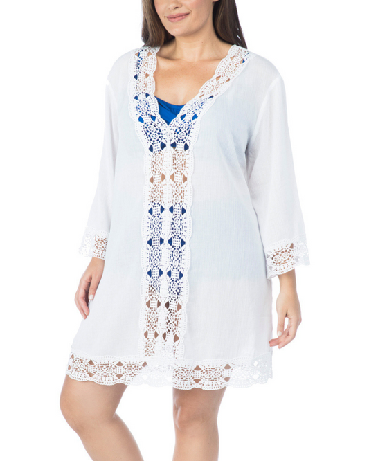Model wearing a v-neck tunic with a 3/4 sleeve in white with crochet trimmingsModel wearing a v-neck tunic with a 3/4 sleeve with crochet trimmings in white