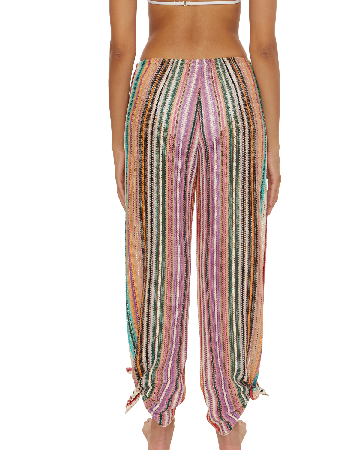 Model wearing a split multi-way cover up pant with adjustable ties at the ankle in a striped red, green, white, pink and orange print