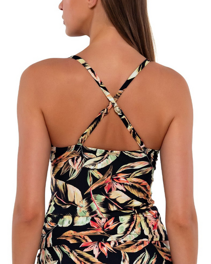 Model wearing a tankini top with shirred mid section in a black, green and red tropical print. 