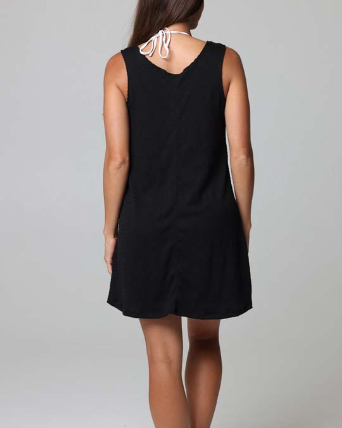 Model wearing a ring tank cover up dress in black