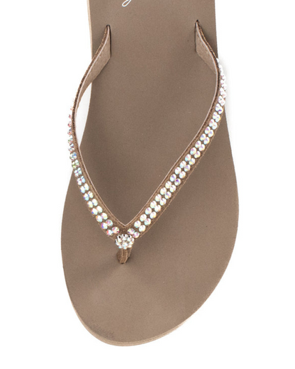 Top view of a taupe wedge sandal with rhinestones on the strap on a white backdrop. The sandal has 1.75" heel height and 0.75" platform height.