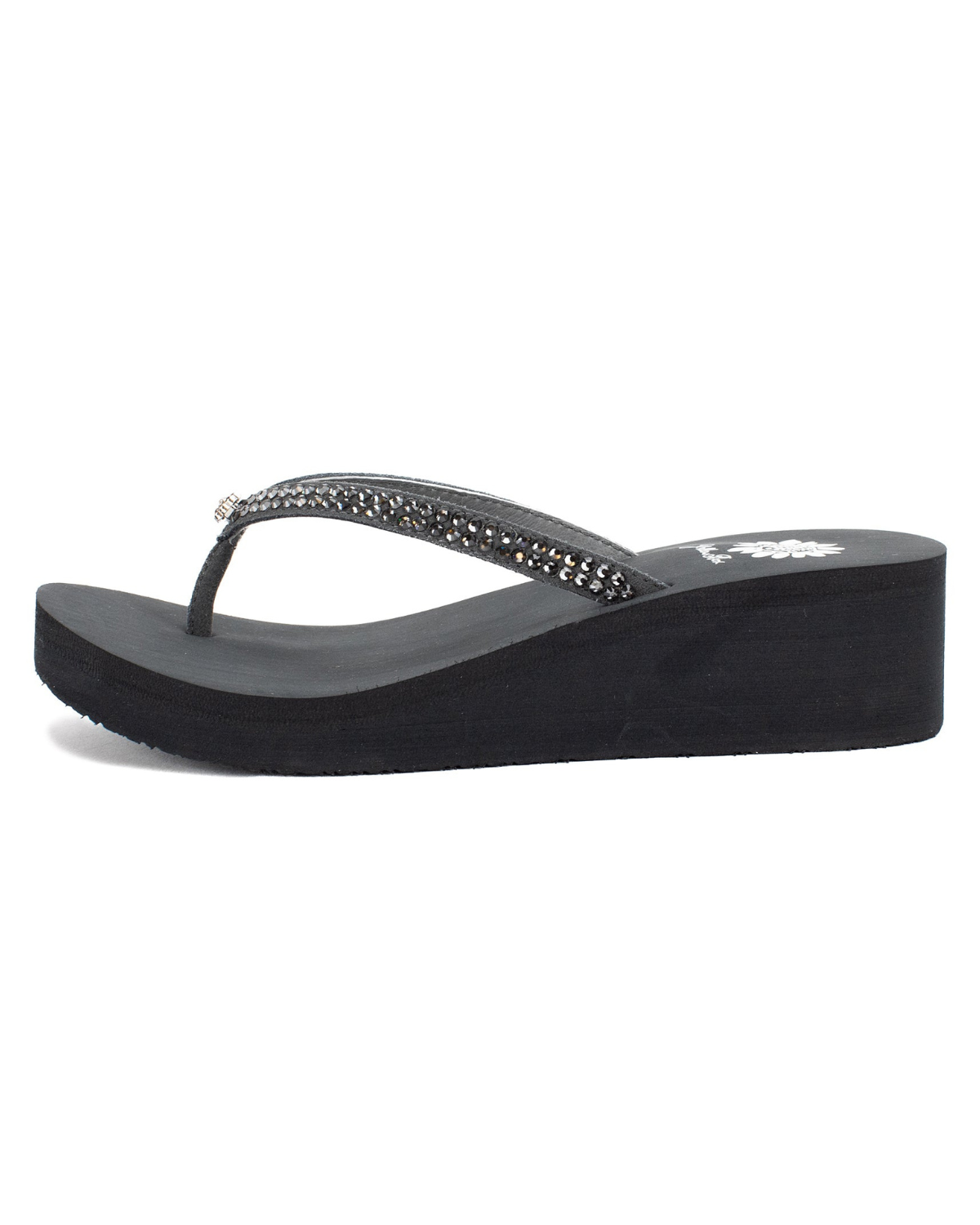 Side view of a black wedge sandal with rhinestones on the strap on a white backdrop. The sandal has 1.75" heel height and 0.75" platform height.