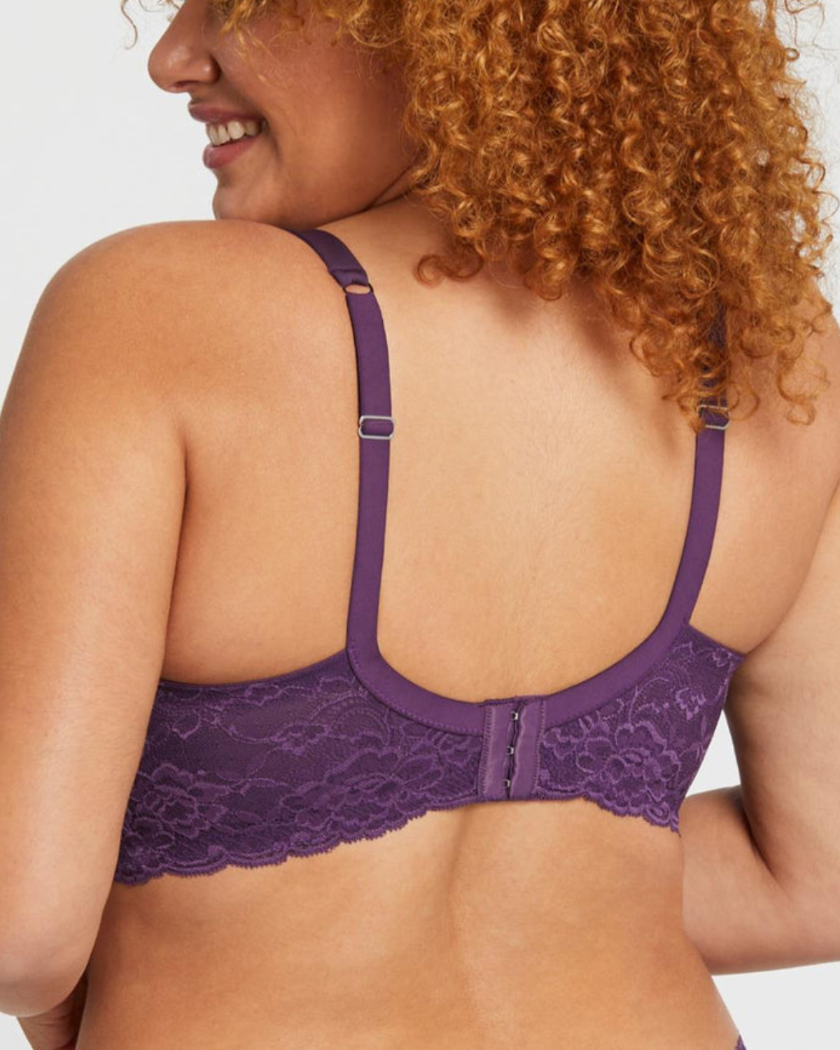 Model wearing a molded t-shirt underwire bra with lace wings in purple
