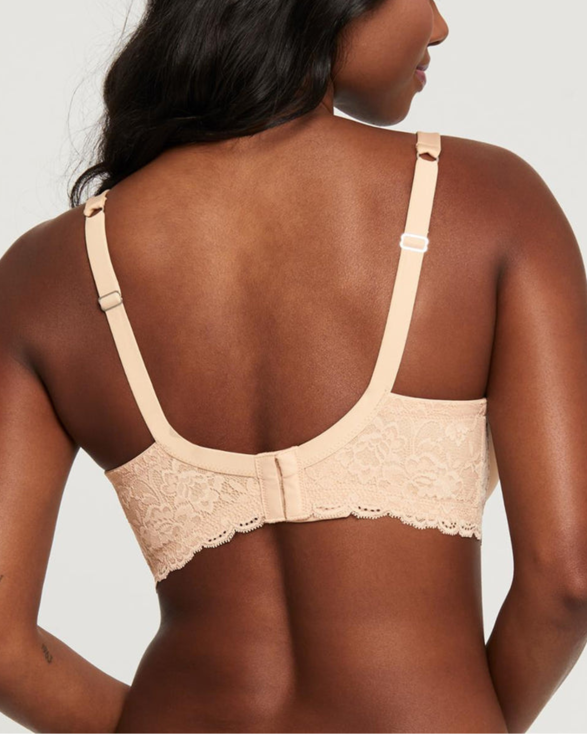 Model wearing a molded t-shirt underwire bra with lace side wings in beige