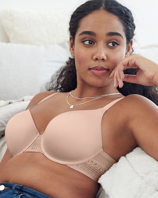 Model wearing a molded underwire t-shirt bra with lace on the wings in light pink