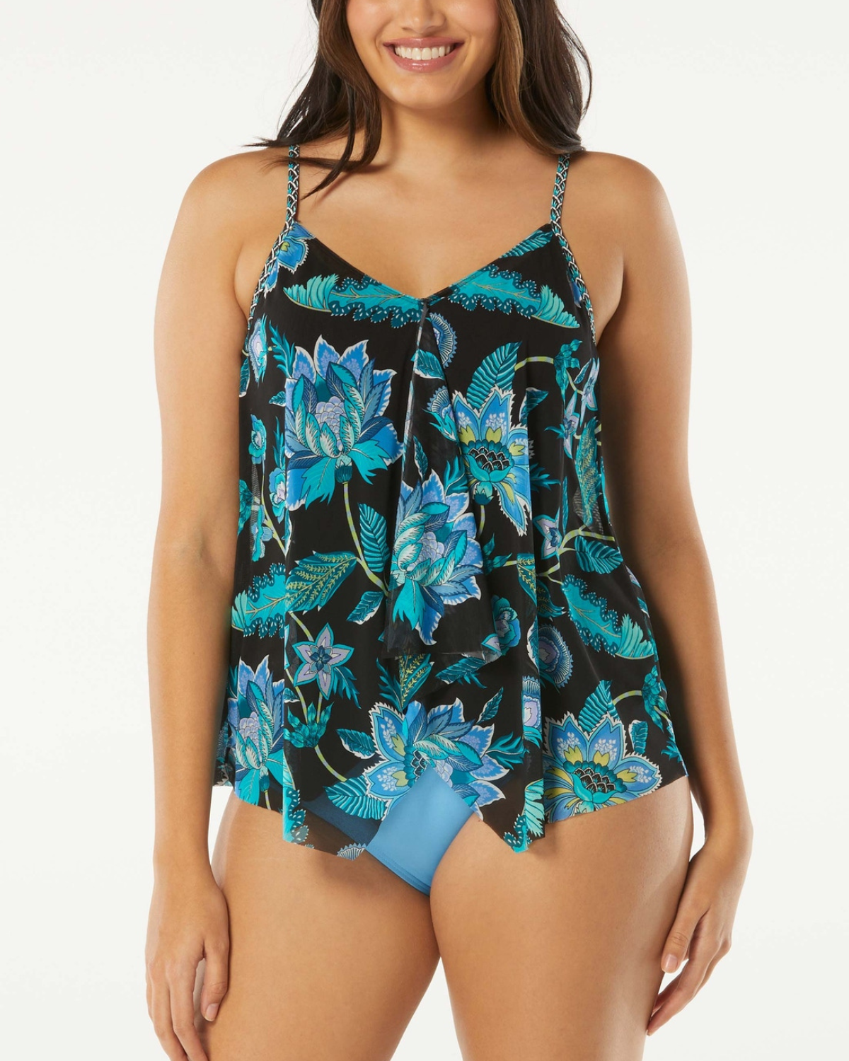 Model wearing a mesh layer tankini top in black with green and blue floral print