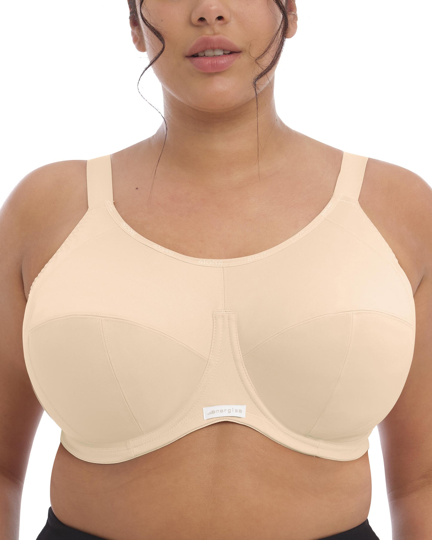 Model wearing an underwire sports bra in nude/ beige