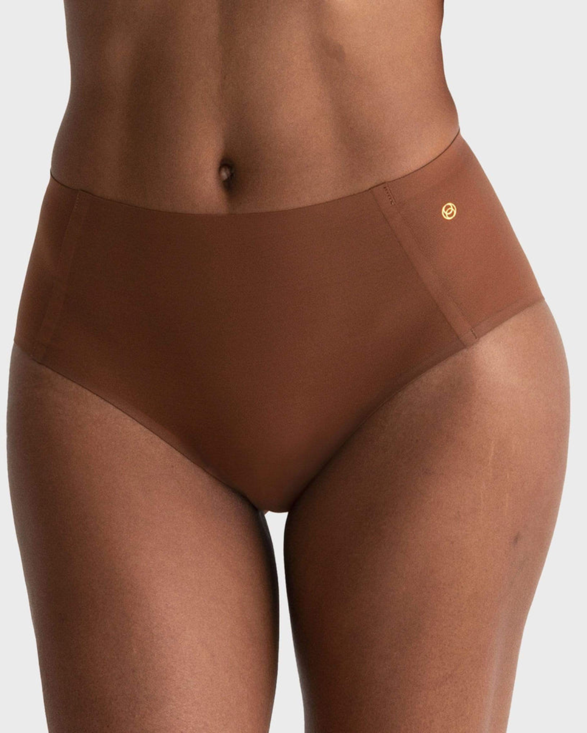 Model wearing a dark nude high waist seamless brief panty