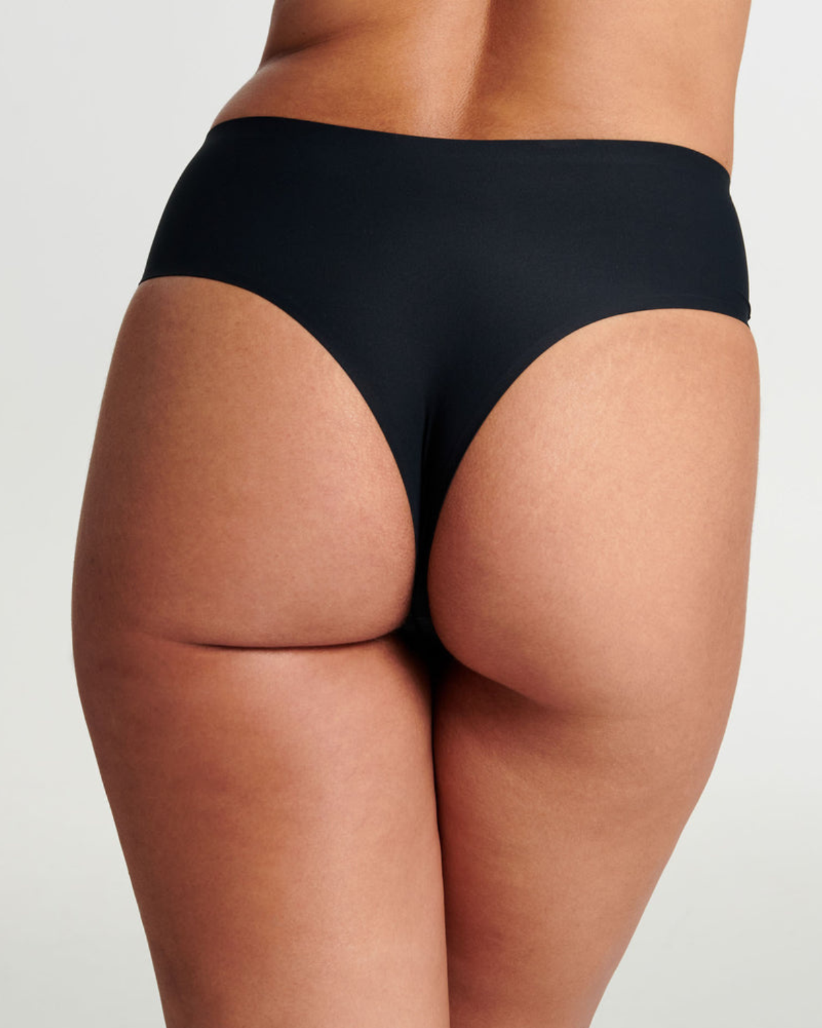 Model wearing a black high waist seamless thong