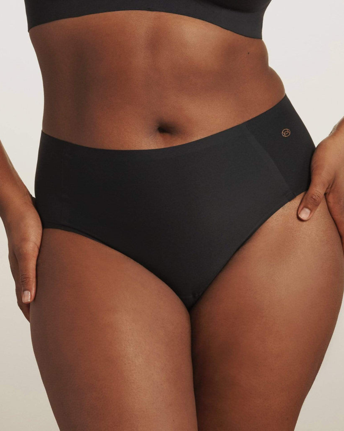 Model wearing a black high waist seamless brief panty