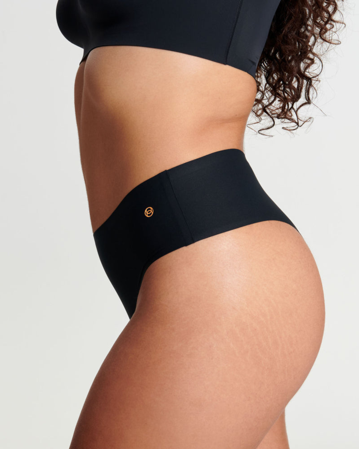 Model wearing a black high waist seamless thong