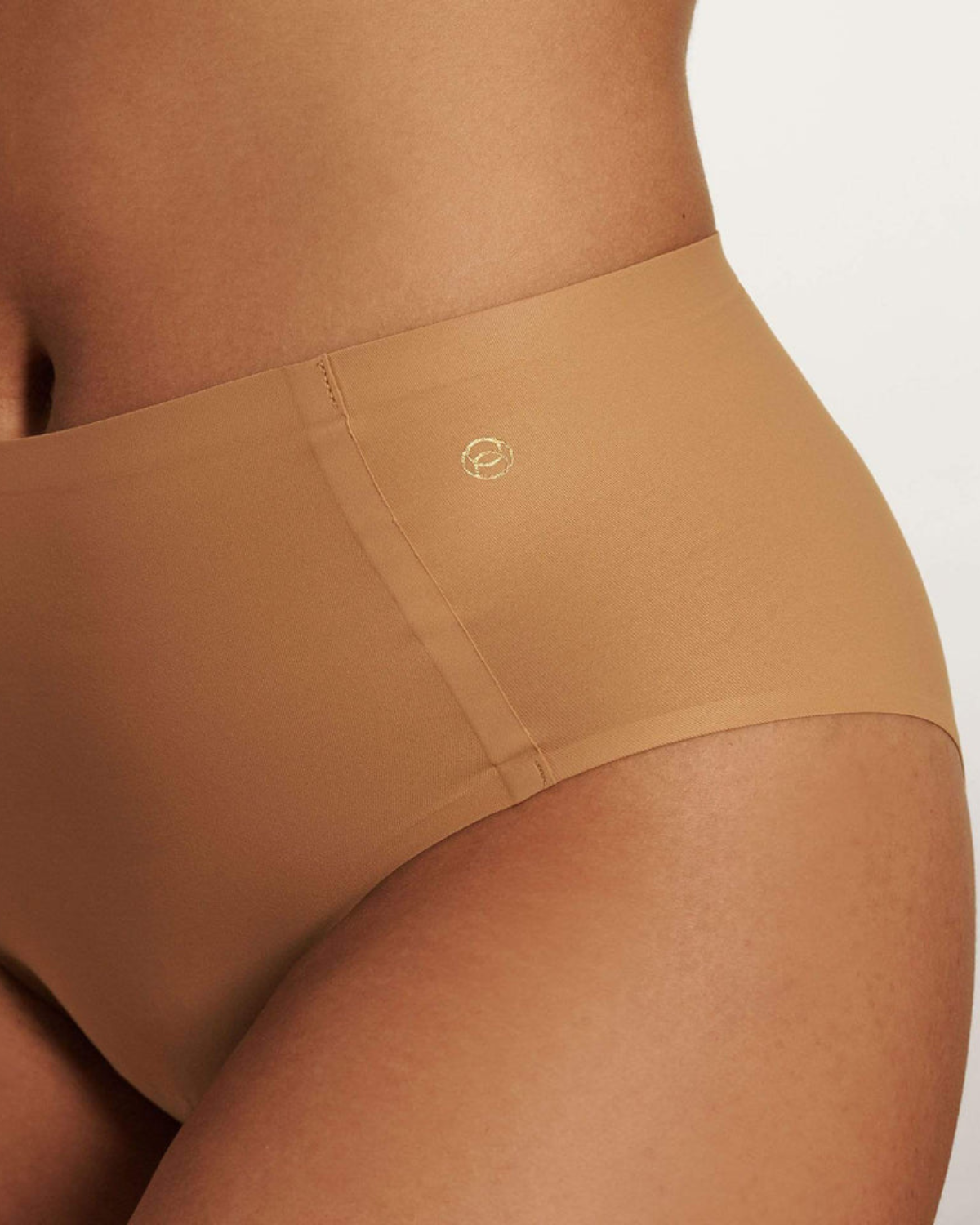 Model wearing a medium nude high waist seamless brief panty