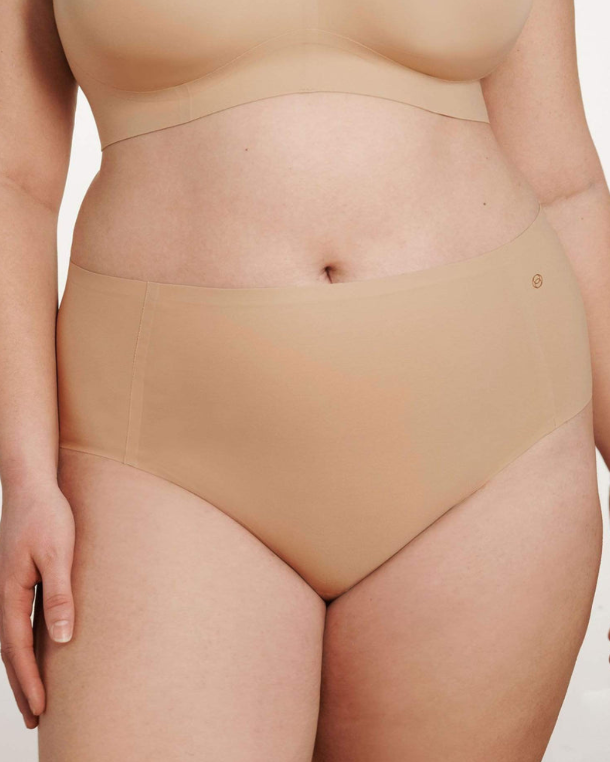 Model wearing a light nude high waist seamless brief panty