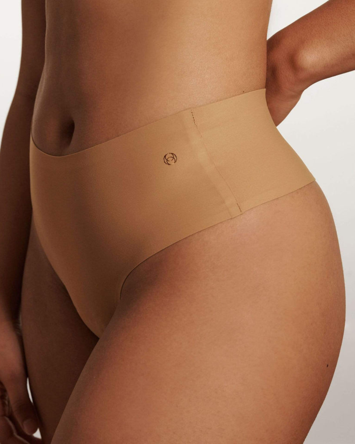 Model wearing a medium nude high waist seamless thong