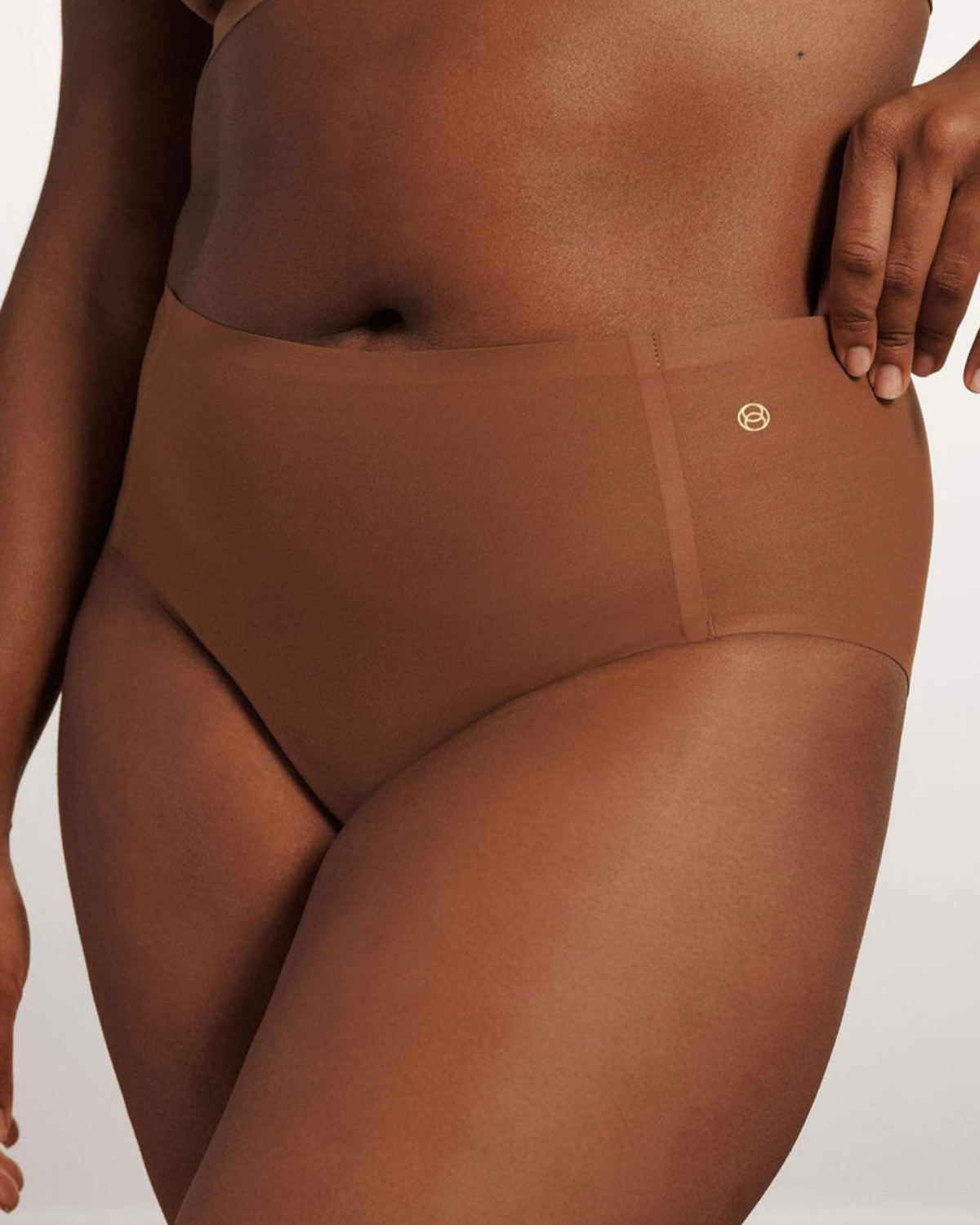 Model wearing a dark nude high waist seamless brief panty