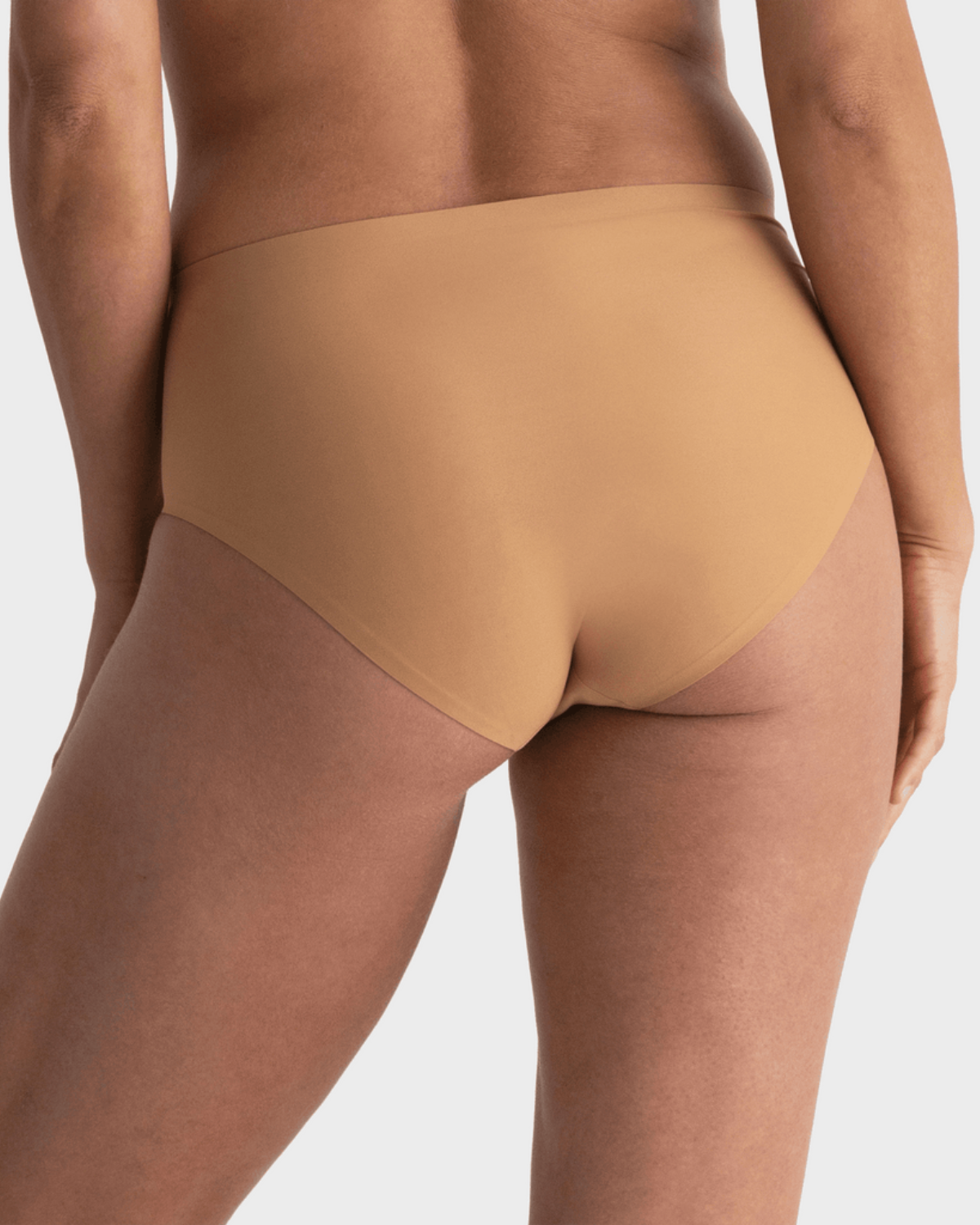 Model wearing a medium nude high waist seamless brief panty