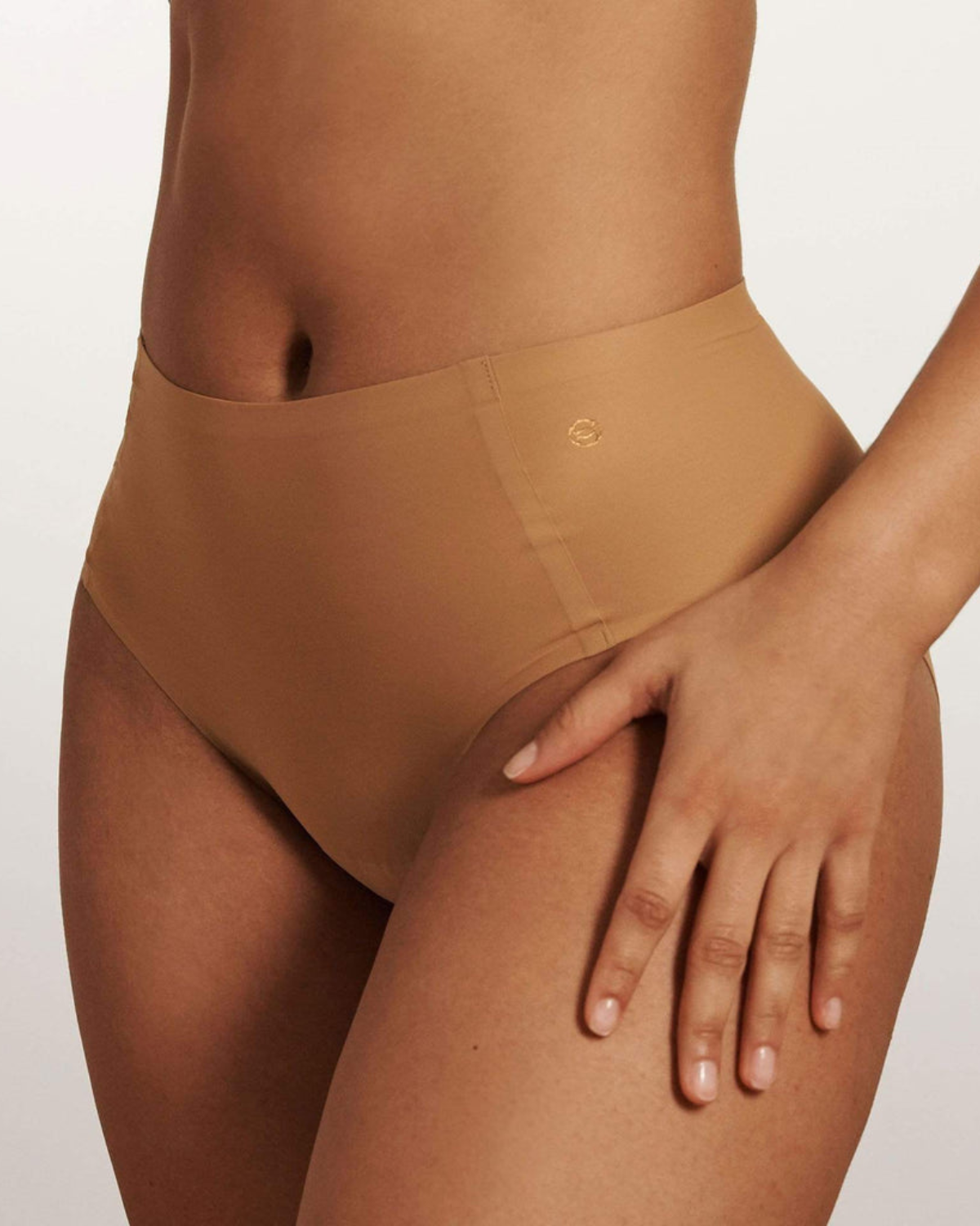 Model wearing a medium nude high waist seamless brief panty