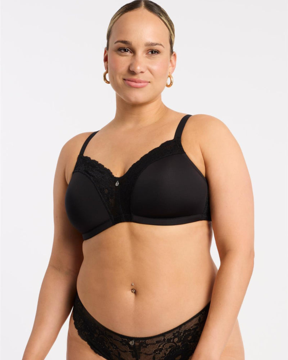 Model wearing a wire free molded cup bra with lace wings in black