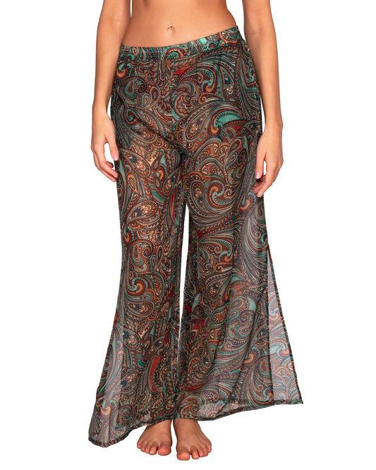 Model wearing a cover up beach pant with side slit in a brown and turquoise paisley print. 