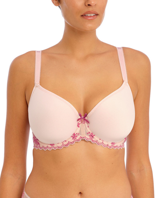 Model wearing a molded spacer underwire bra in pink with lace wings