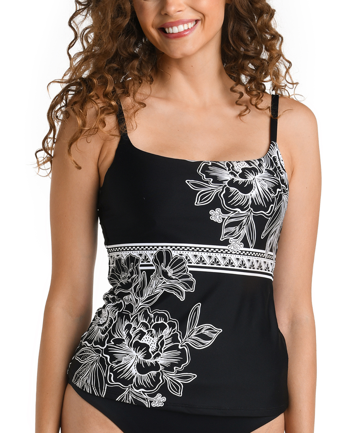 Model wearing an underwire tankini top in black with white floral outline details
