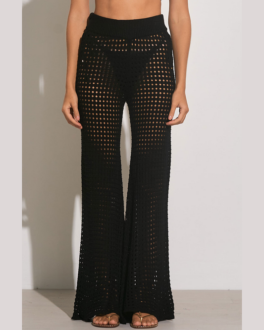 Model wearing a crochet pant cover up in black