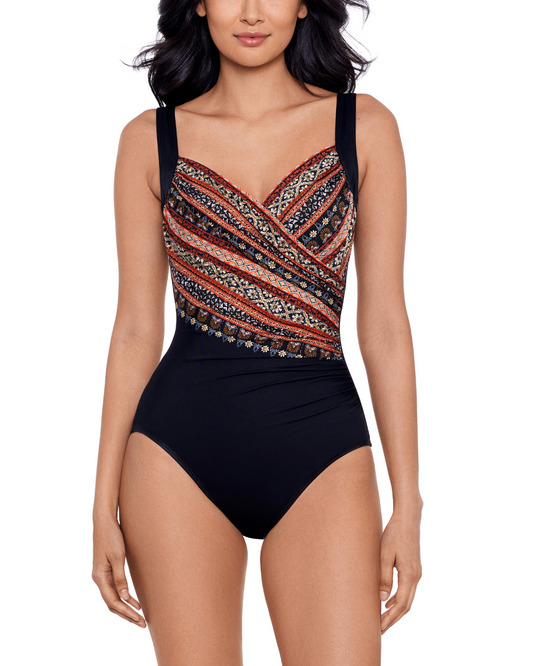 Model wearing a one piece swimsuit with hidden underwire in a black and tribal print