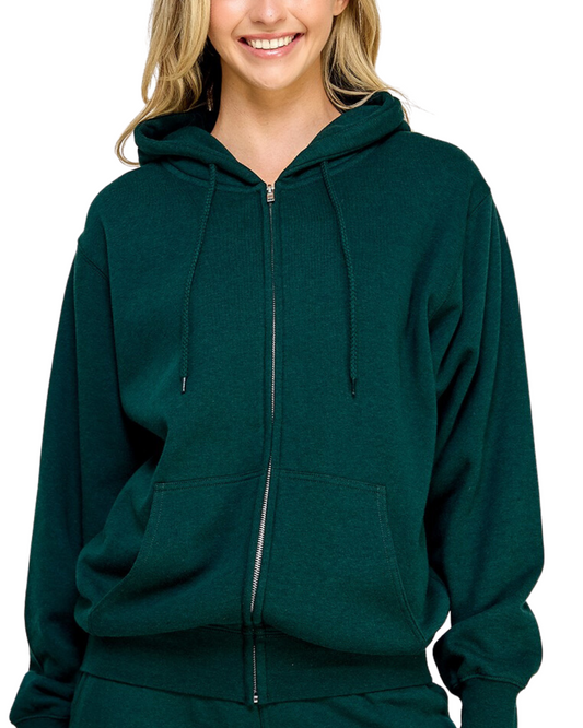 Model on a white backdrop wearing a women's oversized fleece zip up hooded sweater in a solid forest green
