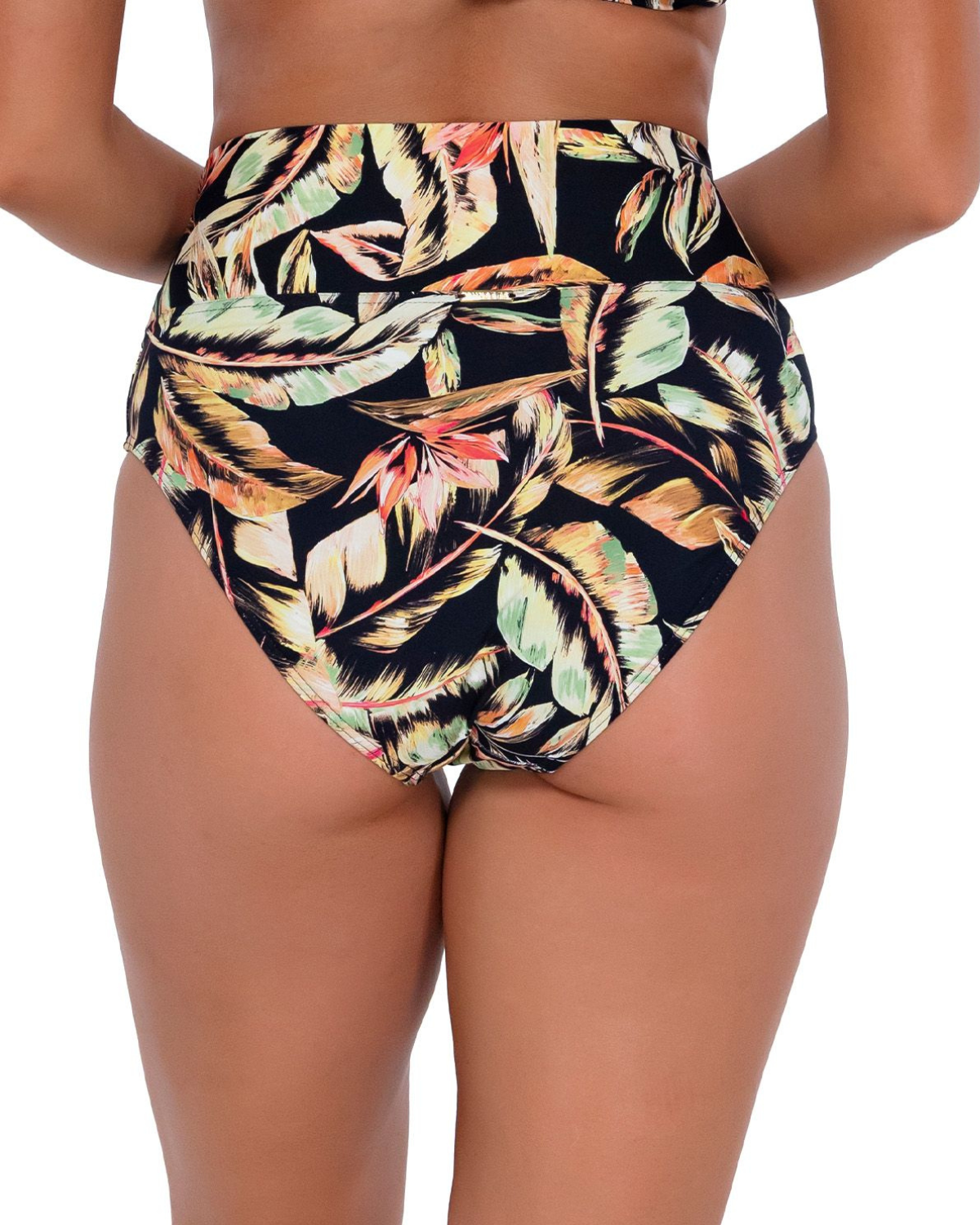 Model wearing a high waist fold over bikini bottom in a black, green and red tropical print. 