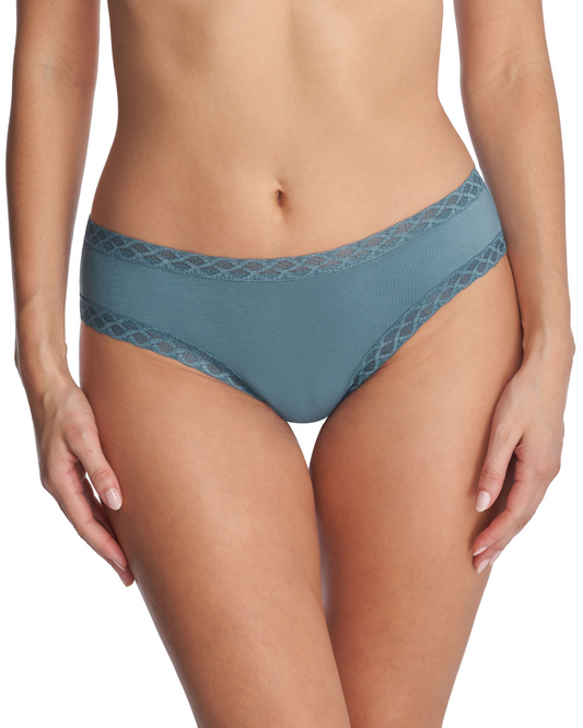 Model wearing a brief panty with lace trim in pale turquoise