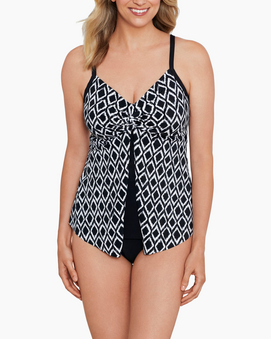 Model wearing a flyaway tankini top in a black and ivory ikat print