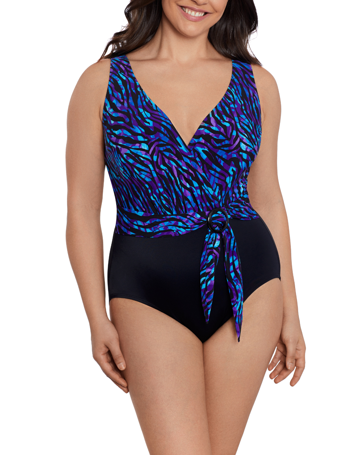 Model wearing a v-neck belted one piece swimsuit in a black base and black, purple, and navy animal print top half