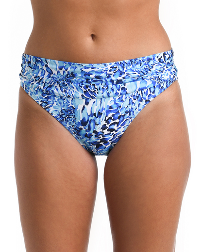 Model wearing a shirred hipster bottom in a blue and white aquatic print
