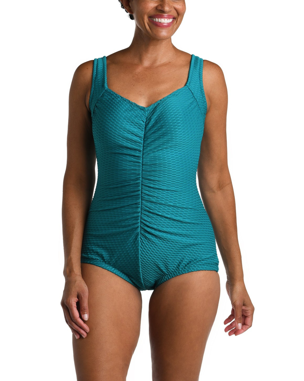 Model wearing a textured one piece swimsuit with a girl leg cut in emerald