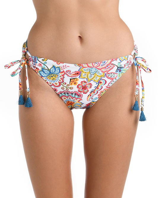 Model wearing a tie side bikini bottom in a white multicolored gypsy floral print