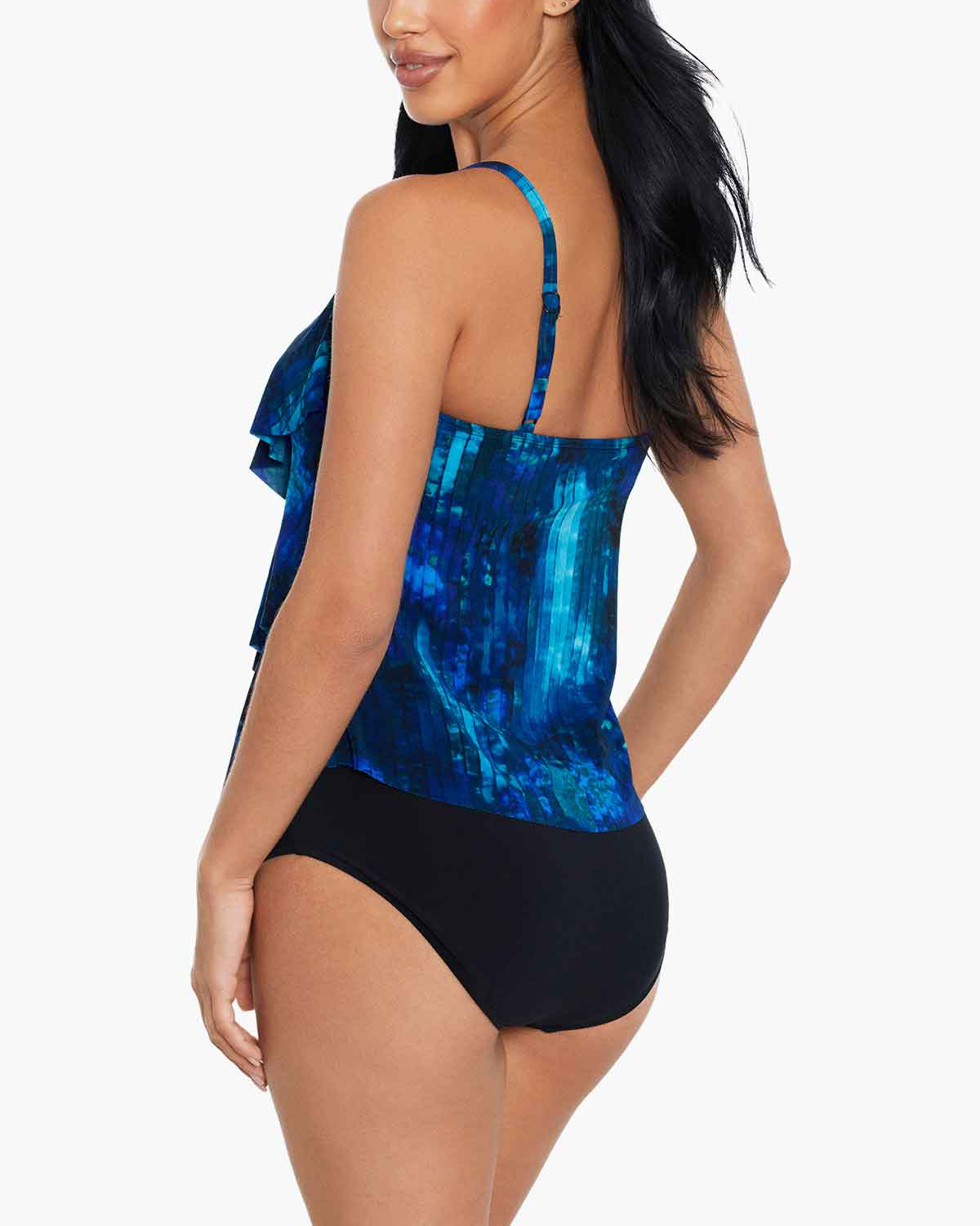 Model wearing a ruffle tankini top in an abstract blue, navy and white print top