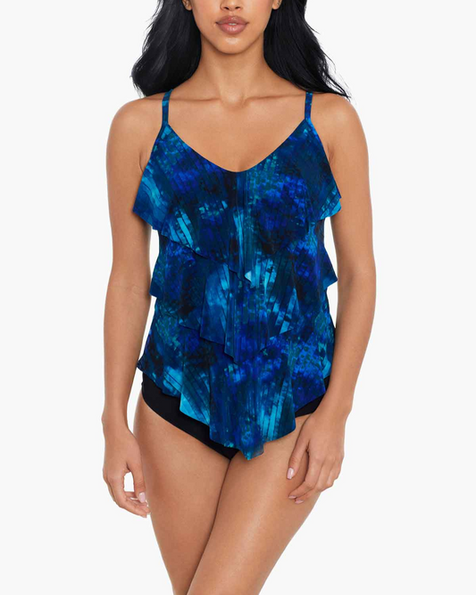 Model wearing a ruffle tankini top in an abstract blue, navy and white print top