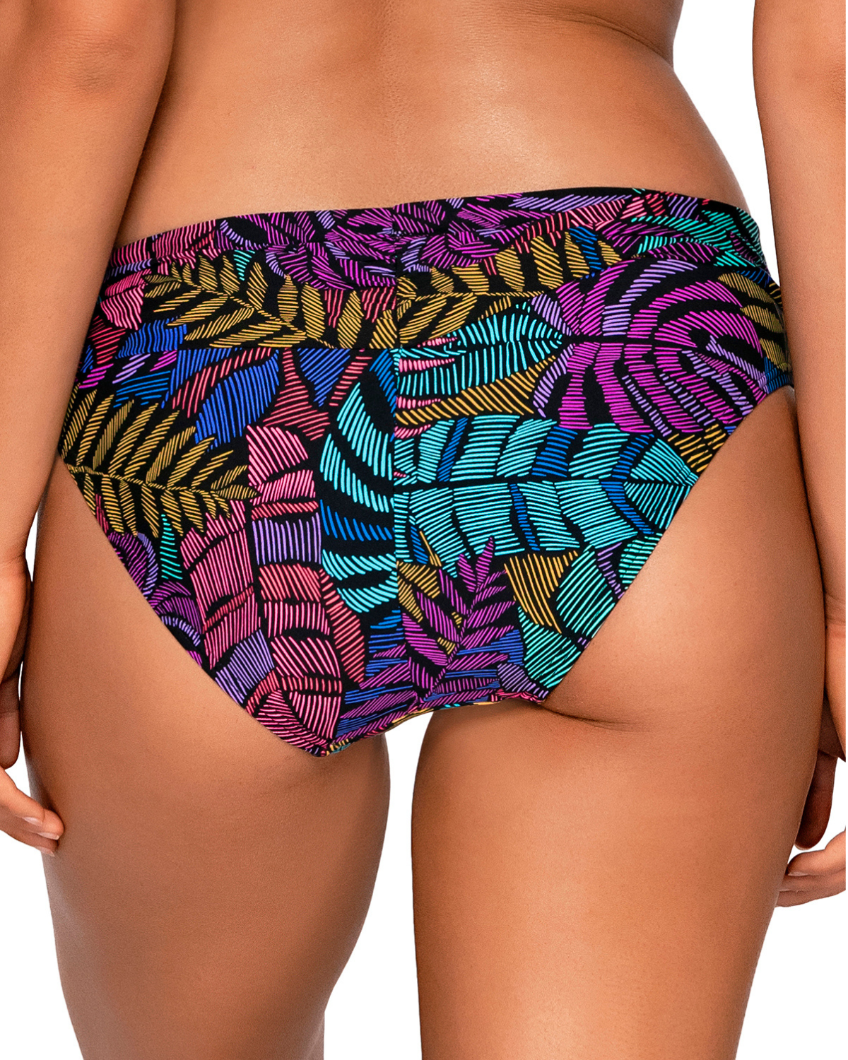 Model wearing a hipster bottom in a pink, purple, blue and yellow palm frond print.